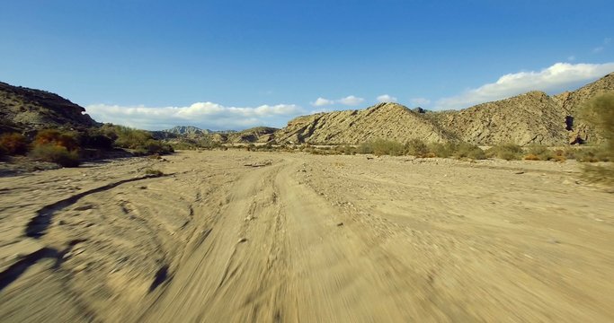 4K Aerial, Flight over a dry riverbed in a desert in Andalusia, Spain - Shot is additionally stabilized, graded and mostly accelerated. Watch also for the native versions