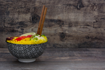 Thai noodles and curry on wood
