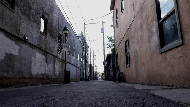 Dolly shot of a grungy city alley