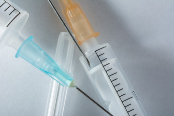 syringes with needles on a white background  - obrazy, fototapety, plakaty