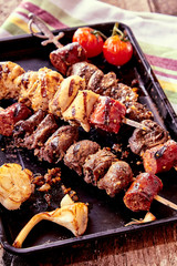 Grilled Meat Skewers and Vegetables on Hot Pan