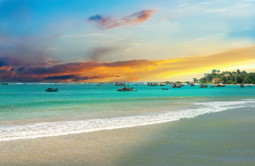 Beautiful sunrise, tropical beach , turquoise ocean water .