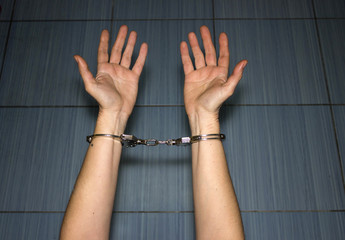 Handcuffs on hands