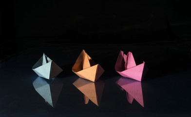 three colored paper boats