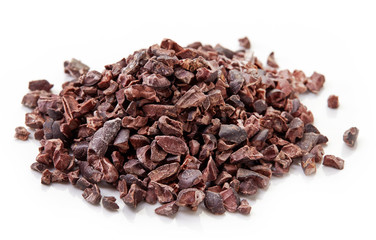 Heap of cacao nibs on white background
