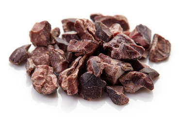 Heap of cacao nibs on white background
