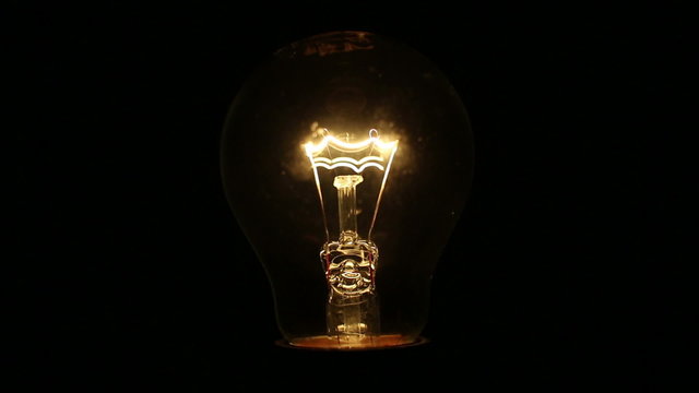 A light bulb illuminates a dark room, much like an idea in our mind.