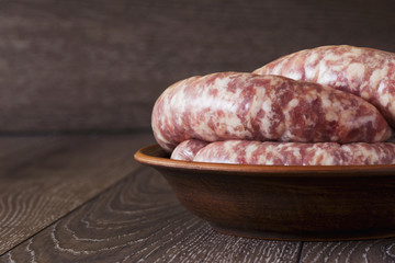uncooked sausages in a plate