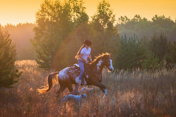 Girl riding on the red-and-white Appaloosa horse