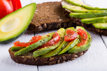 Tasty avocado sandwich with tomato and seasoning for slimming.