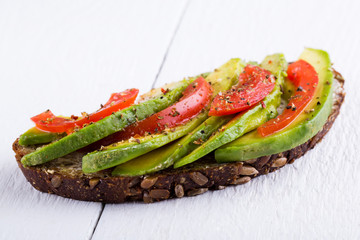 Tasty avocado sandwich with tomato and seasoning for slimming.