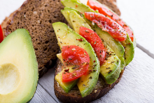 Tasty avocado sandwich with tomato and seasoning for slimming.