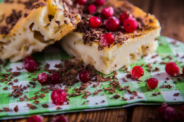 Apple pie on  napkin and wood surface with chocolate, cranberries