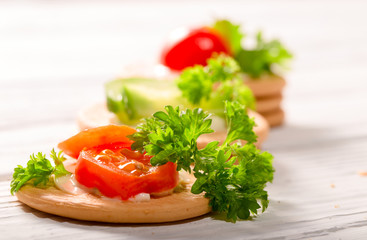 Cheese, tomatoes and greens of parsley on cookies