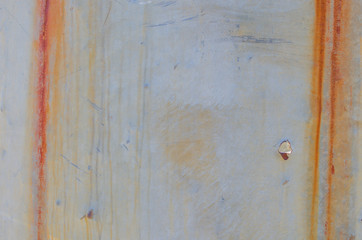 Vertical Streaks of Rust and Bullet Hole on Sheet Metal