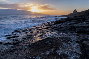 Sun rise on winter morning at Cullernose Point on the coast of Northumberland, England, UK.