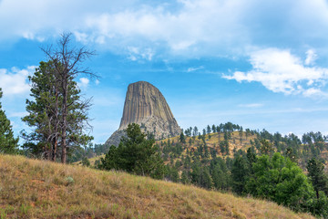 View of Devils Tower with rolling hills in the foreground in Wyoming