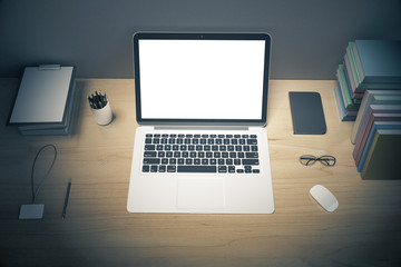 Blank laptop screen with diary, books and othe office accessorie