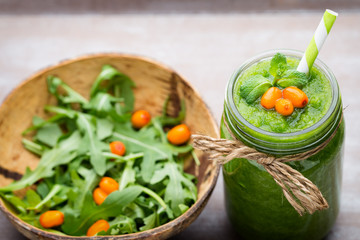Rucola smoothie, on the grey  background.