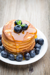Stack of pancakes with blueberry and fresh berry.