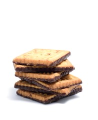Stack of butter cookies with dark chocolate topping on a white background.