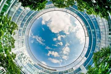 Upward view of office building from patio - Powered by Adobe