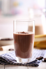 Glass of chocolate milk on table close-up