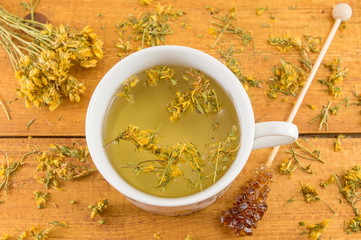 St Johns wort tea and surrounded by dried plants