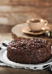 Tasty chocolate cake on wooden background