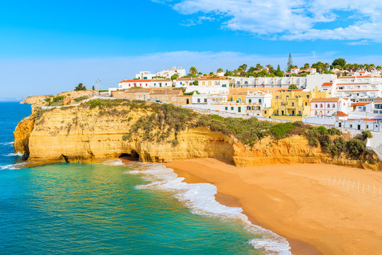 A view of beach with colourful houses in Carvoeiro fishing village, Portugal