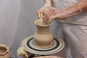 Hands of a potter making jug. Professions