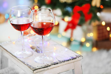 Two glasses of red wine on Christmas decoration background