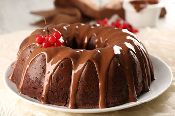 Chocolate cake with snow ball tree berries on plate on a table