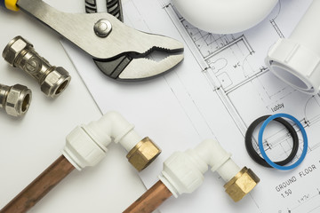 Close up of plumbing paraphernalia on house blueprint