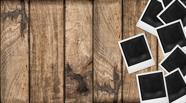 Polaroid photo frames wooden background. Wood table texture