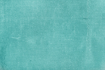 Old cement wall with net and stains, texture concrete background. Turquoise, motton blue, mint and tiffani colors