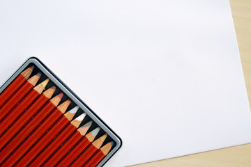 Color pencils in box on white paper background