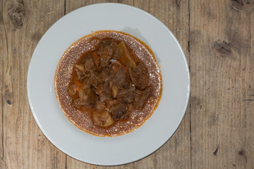 Lamb navarin from above. French spring stew with lamb and vegetables, prepared by a restaurant chef
