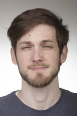 Obraz premium Barely closed eyes, portrait young man in 20s.