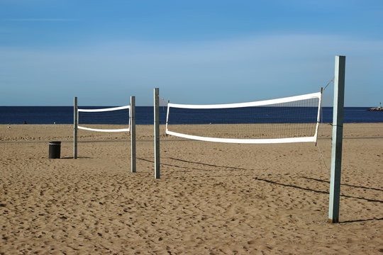 Volleyballfeld am Strand / Ein Beachvolleyballfeld mit einem Volleyballnetz am Strand von Long Beach mit Blick auf den Ozean.