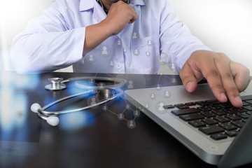 Doctor working with digital tablet and laptop computer in medica
