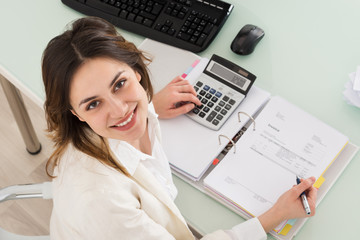 Businesswoman Calculating Invoice
