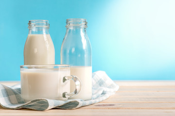 Milk bottle and milk glass put on wooden.