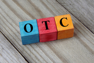 OTC (Over The Counter) acronym on colorful wooden cubes