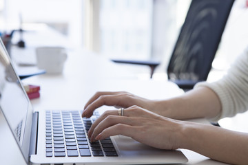 Women are entering the laptop at the office