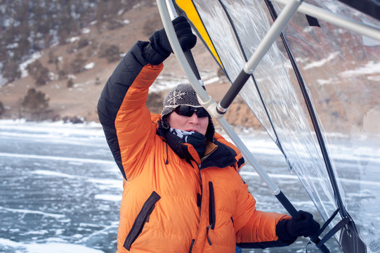 Man standing on ice with wing in the hands.