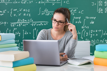 Woman With Laptop And Books At Desk