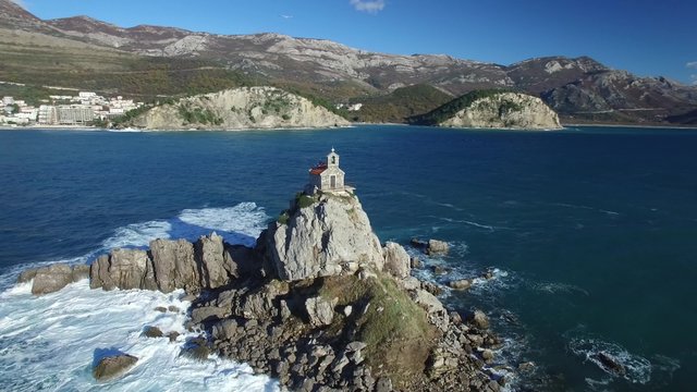 Aerial view of island with church in front of Petrovac. 