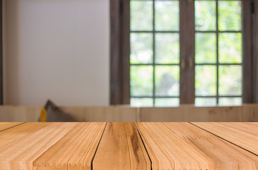 Selected focus empty brown wooden table and Coffee shop blur bac