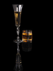 Glass of champagne and whiskey on a black background